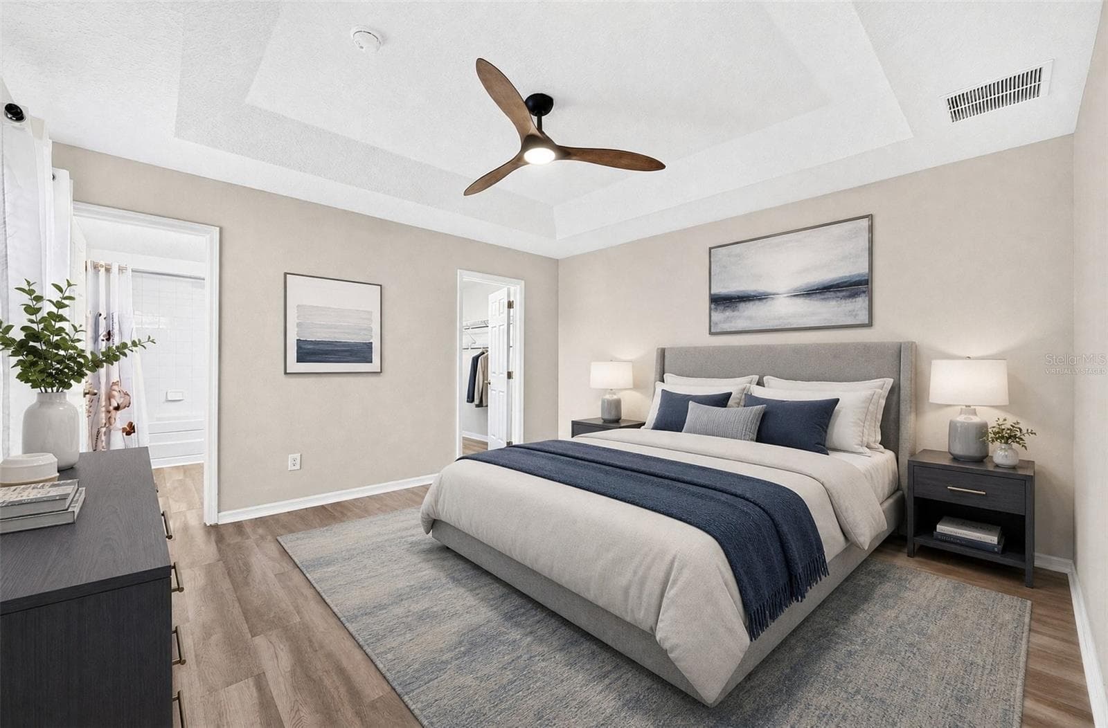 The spacious Primary Suite features a decorative TRAY CEILING, walk-in closet and private EN SUITE BATH. Virtually Staged - 13028 AUBURN COVE LN, ORLANDO