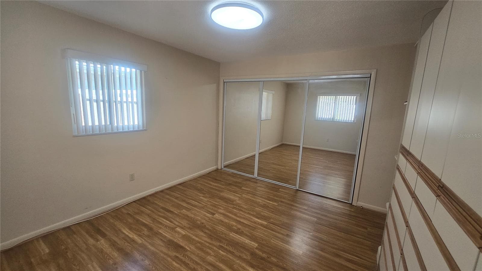 Master bedroom features a closet and built in cabinetry - 10386 112TH WAY N, SEMINOLE