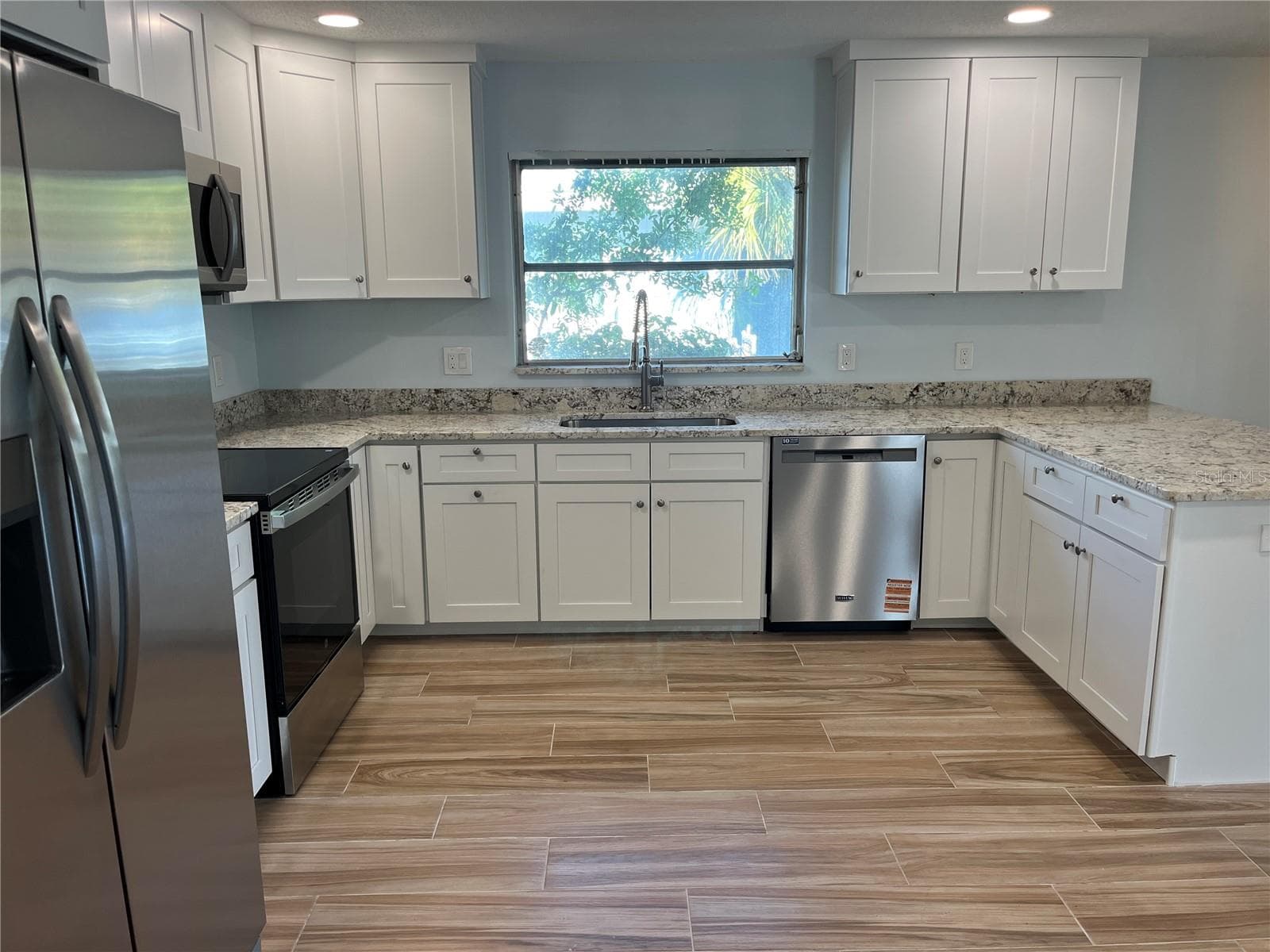 Lovely open kitchen with natural lighting - 307 LA HACIENDA DR, INDIAN ROCKS BEACH