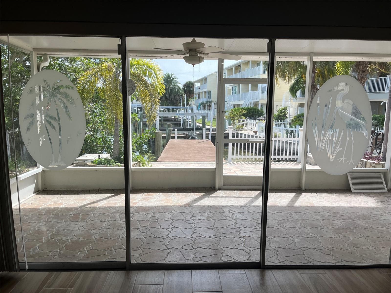 Decorative sliding doors to the covered outside patio - 307 LA HACIENDA DR, INDIAN ROCKS BEACH