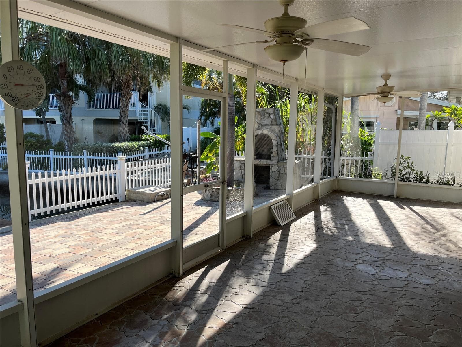 Outdoor covered patio with ceiling fan - 307 LA HACIENDA DR, INDIAN ROCKS BEACH