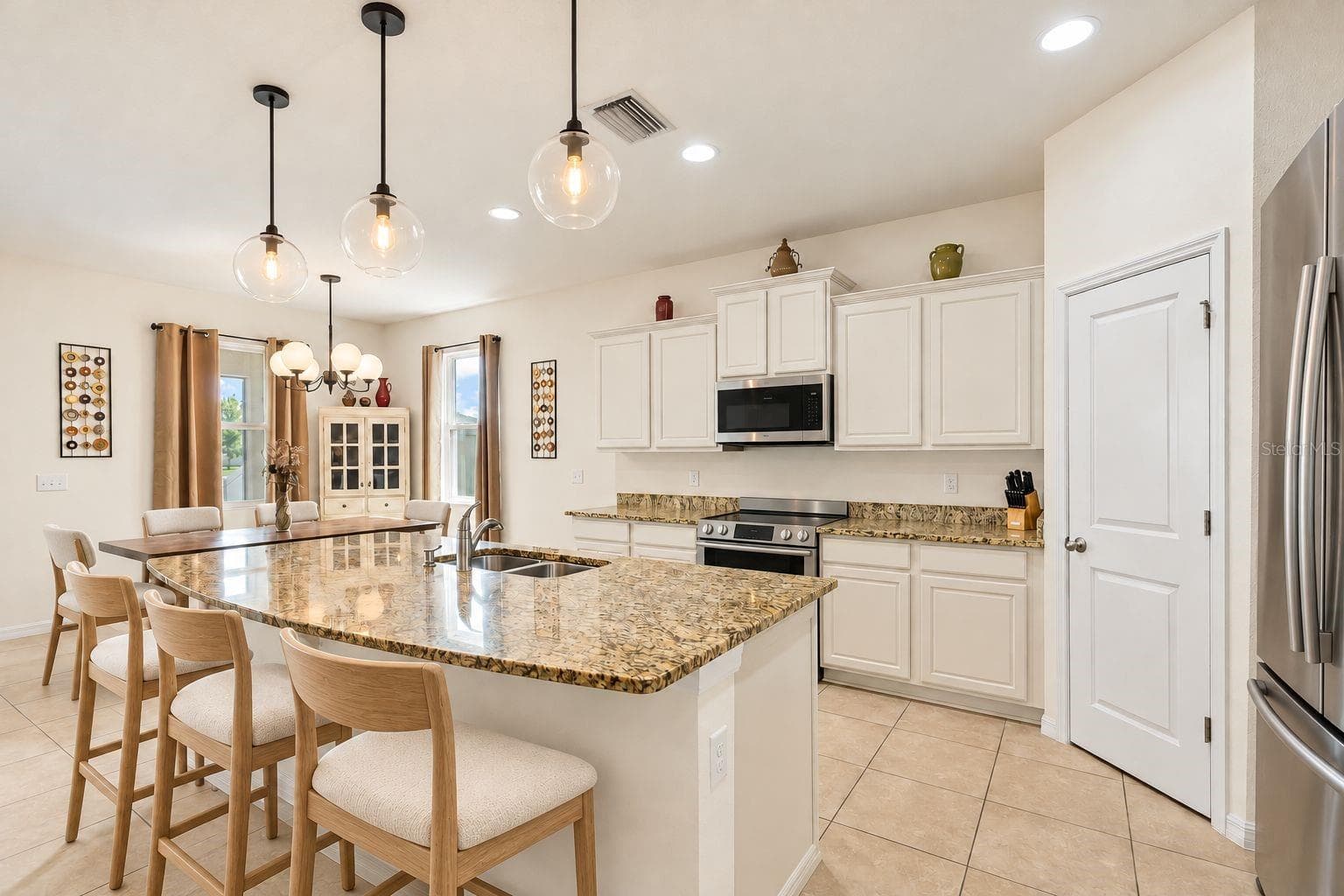 Modified picture to showcase a modern desired kitchen. Changes to cabinet/drawer color, appliances, light fixture, chairs for disclosure purposes. - 5025 JACKEL CHASE DR, WIMAUMA