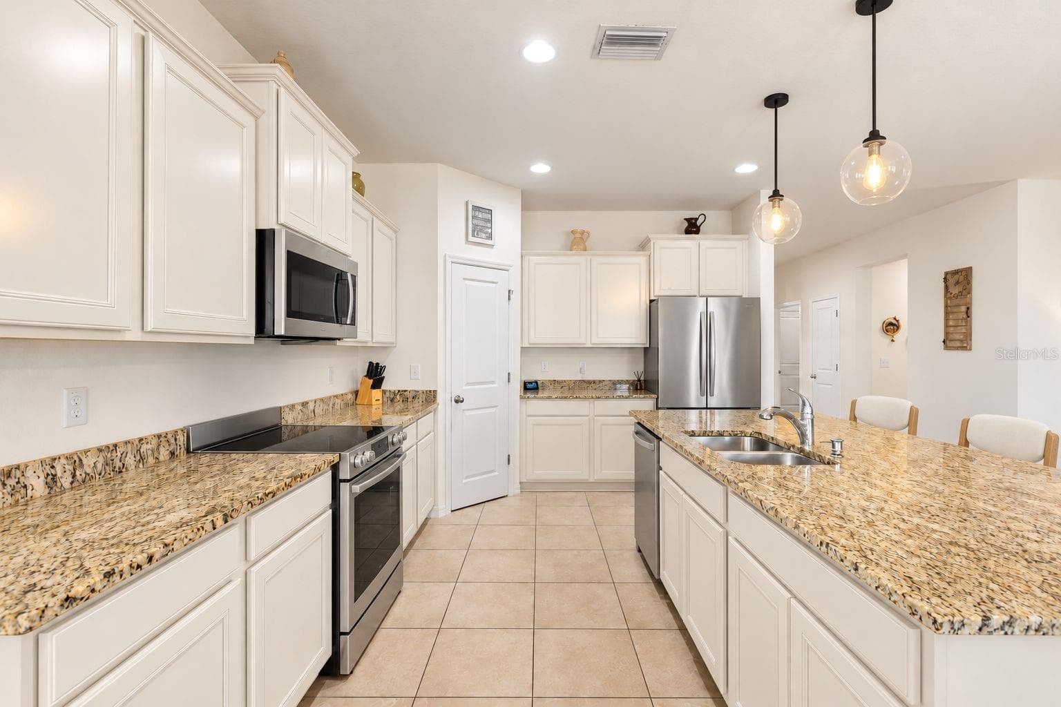 Modified picture to showcase a modern desired kitchen. Changes to cabinet/drawer color, appliances, light fixture, chairs for disclosure purposes. - 5025 JACKEL CHASE DR, WIMAUMA