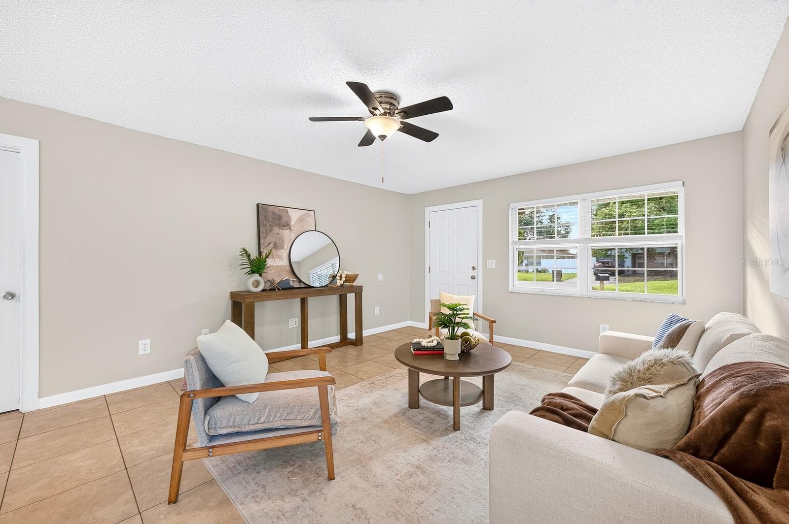 The expansive Living Room invites connection and comfort. - 543 HIBISCUS WAY #9C, ORLANDO