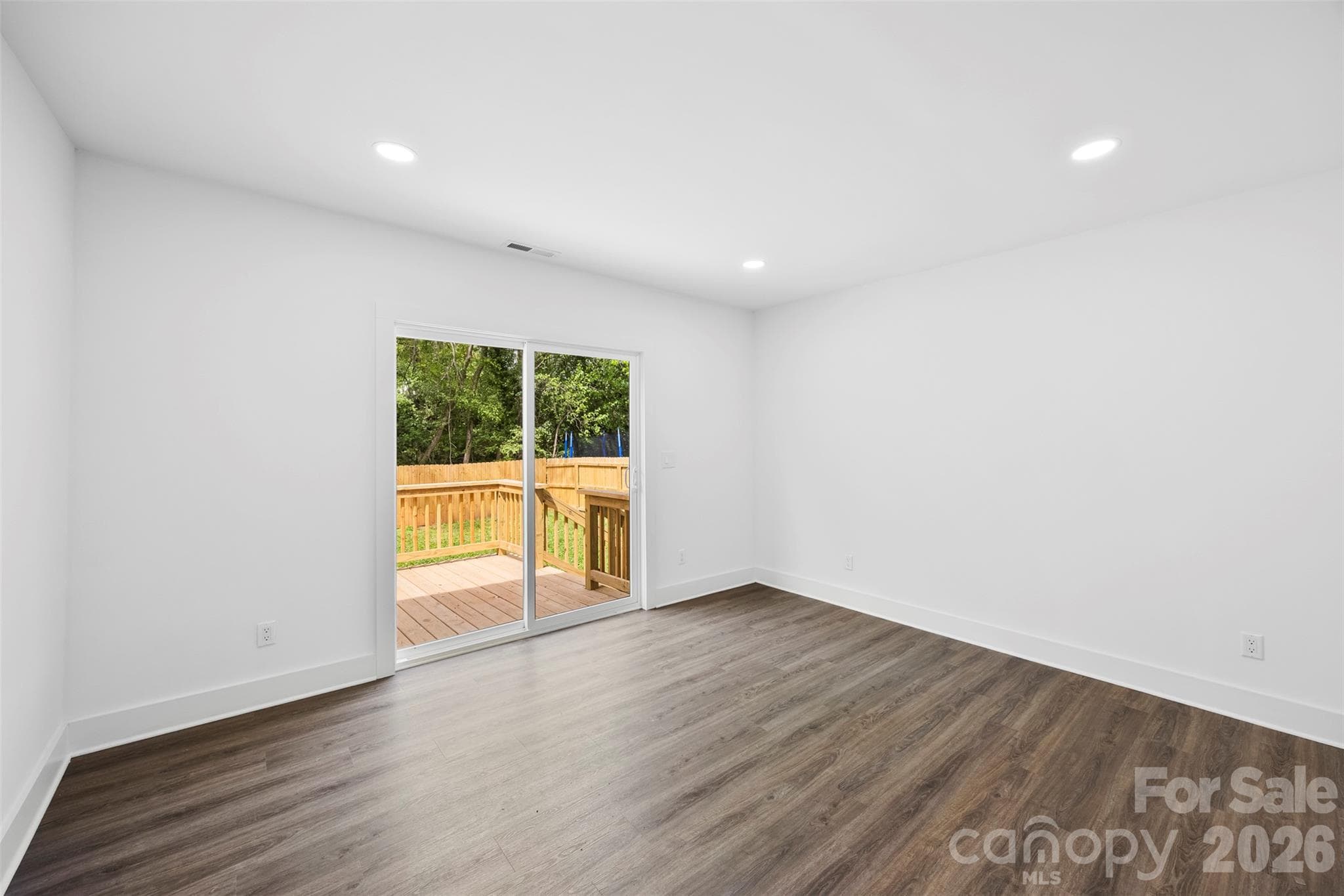 Primary bedroom with access to the back deck. - 2942 Reid Avenue, Charlotte