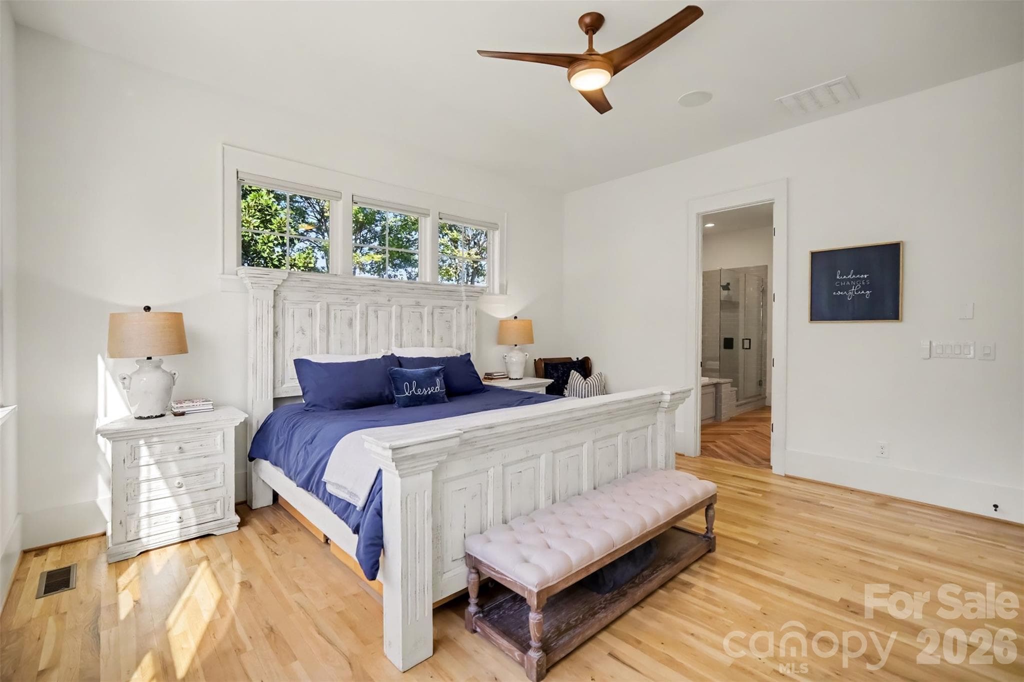 Spacious Primary Suite on Main level with lots of windows and hardwood floors - 206 June Bug Lane, Fort Mill