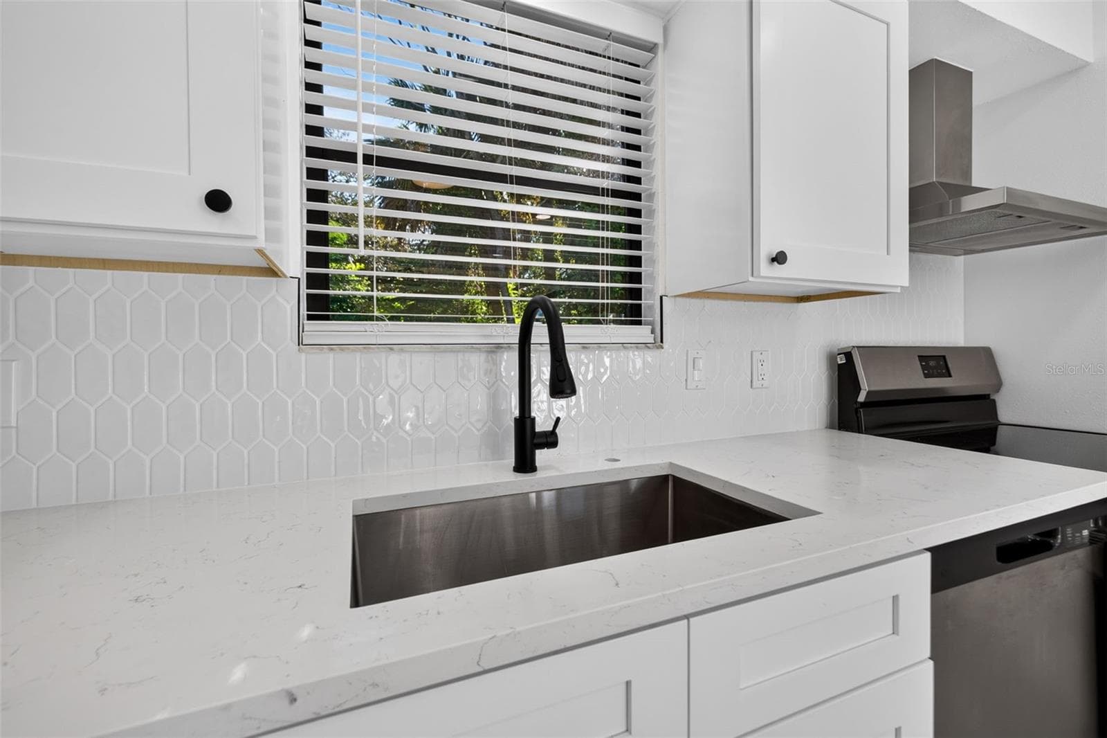 Bright white cabinetry, quartz countertops, and stylish finishes. - 16107 SEA PINES DR, HUDSON