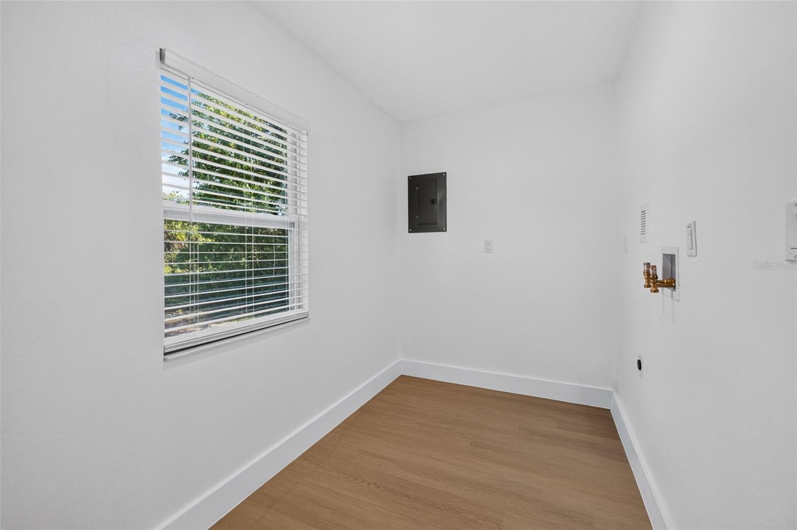 Convenient laundry room off the primary bedroom offers additional storage space. - 16107 SEA PINES DR, HUDSON