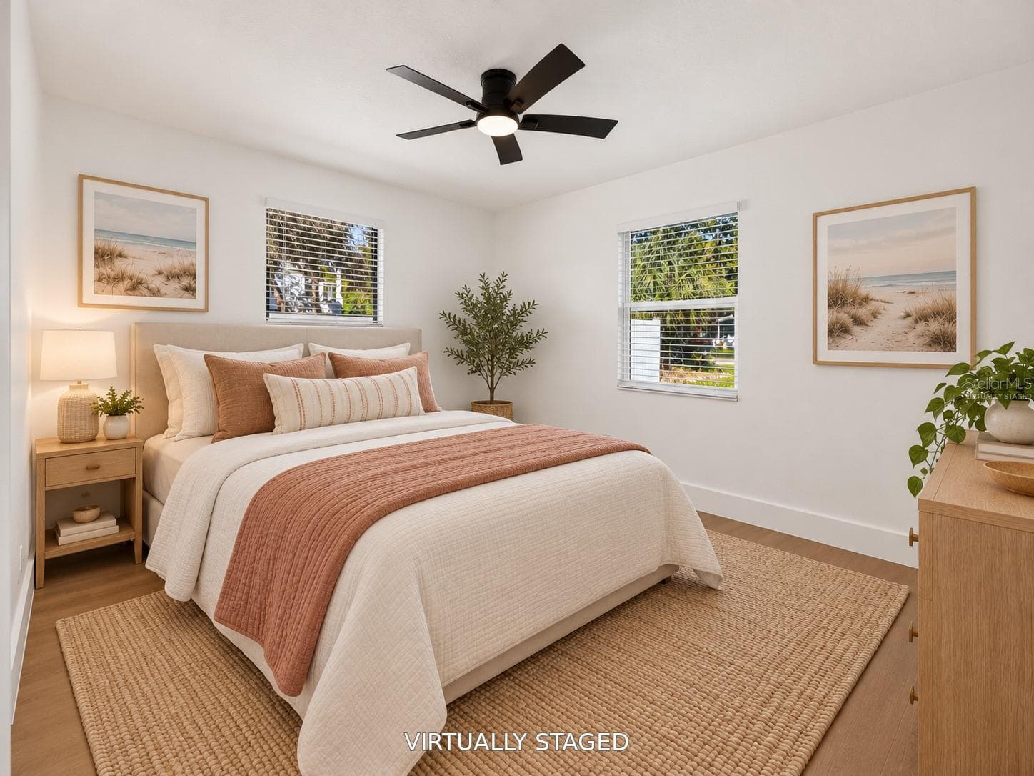 VIRTUALLY STAGED. Bright secondary bedroom featuring updated flooring and a modern black ceiling fan. - 16107 SEA PINES DR, HUDSON