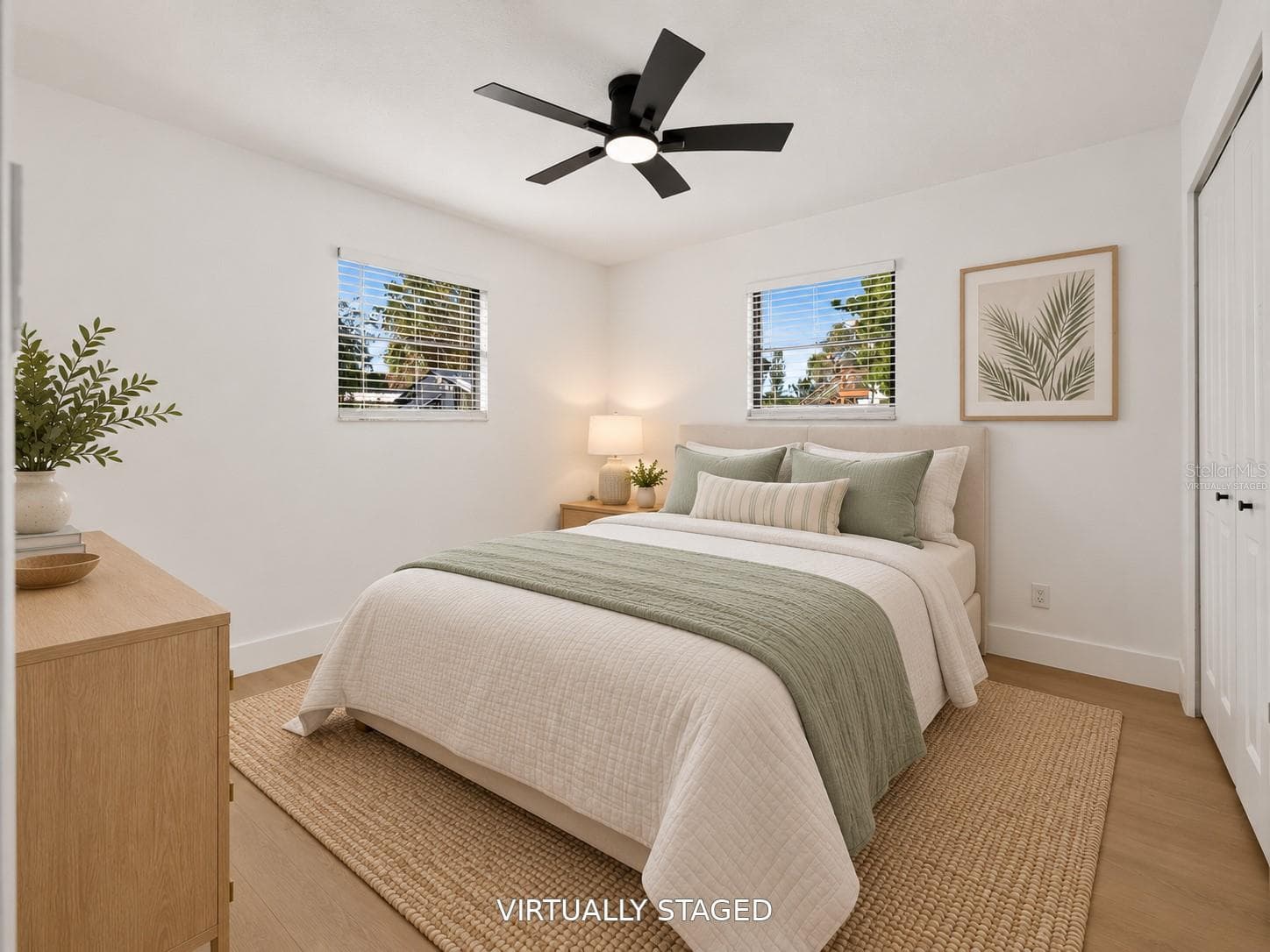 VIRTUALLY STAGED. Additional bedroom featuring a sleek black ceiling fan and updated flooring. - 16107 SEA PINES DR, HUDSON