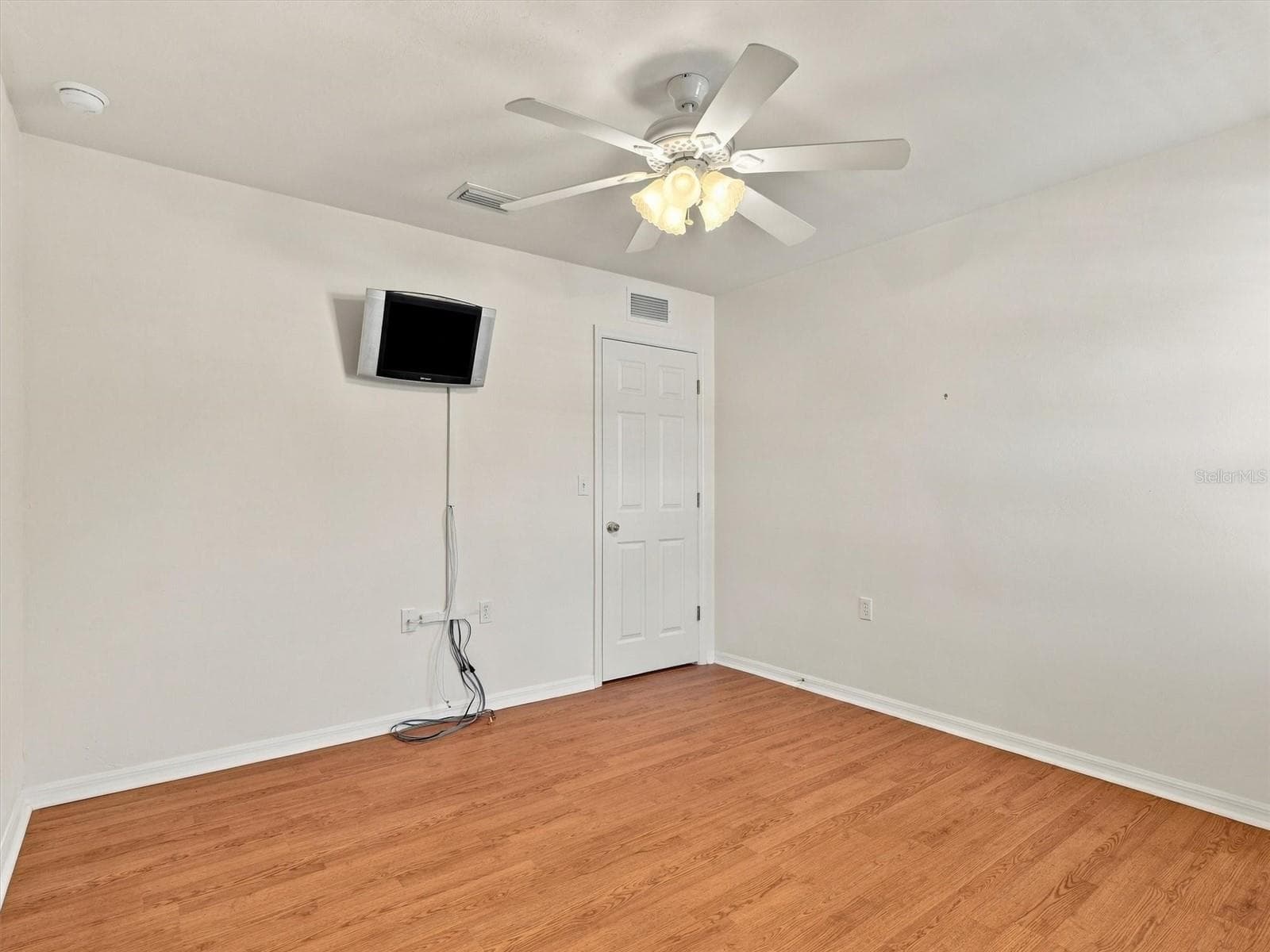 Bedroom 3 with mounted TV and Door to hallway - 11644 NW 18TH PL, GAINESVILLE