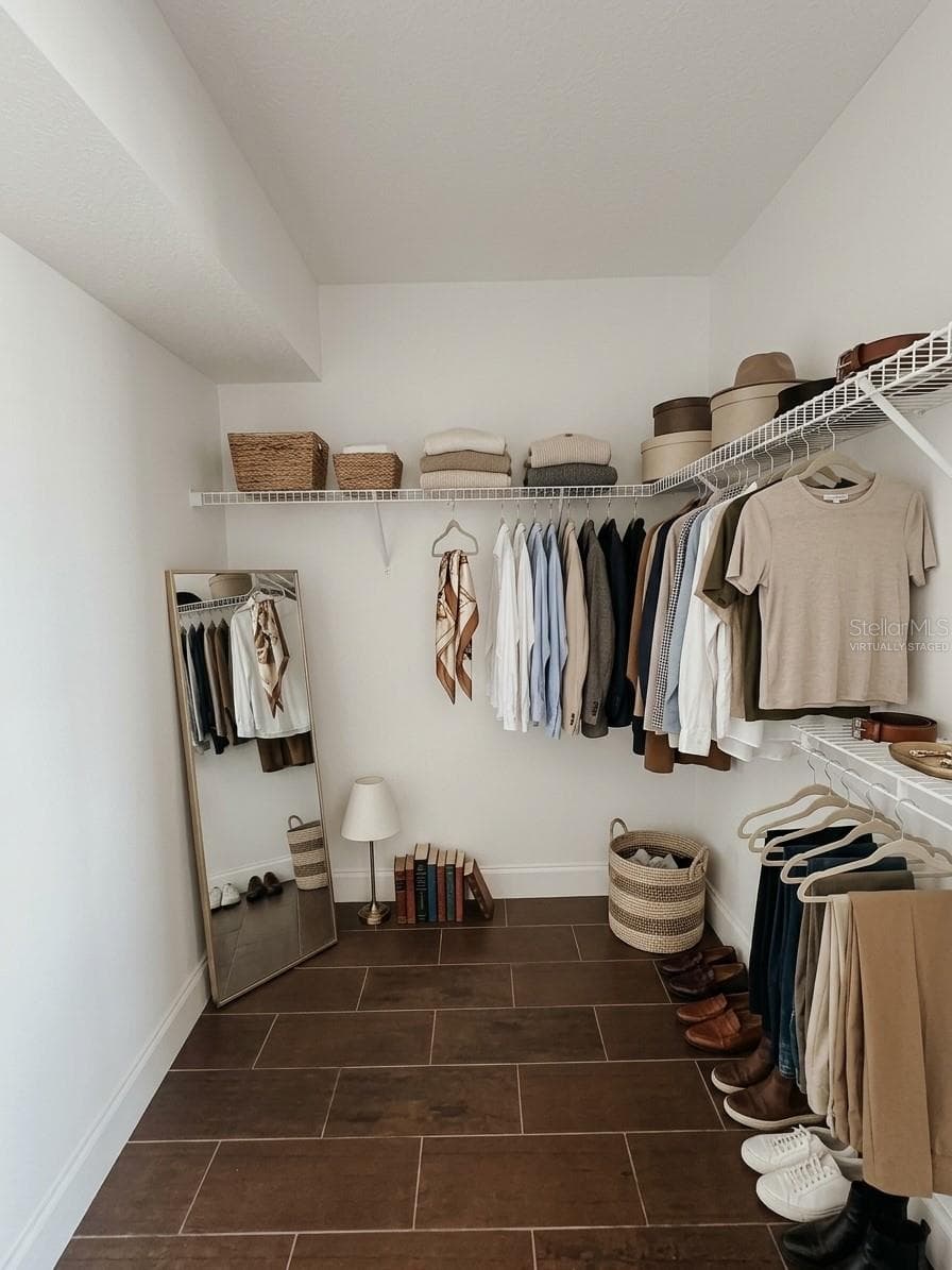 Virtually Staged Primary Bedroom Walk In Closet - 2617 COVE CAY DR #107, CLEARWATER