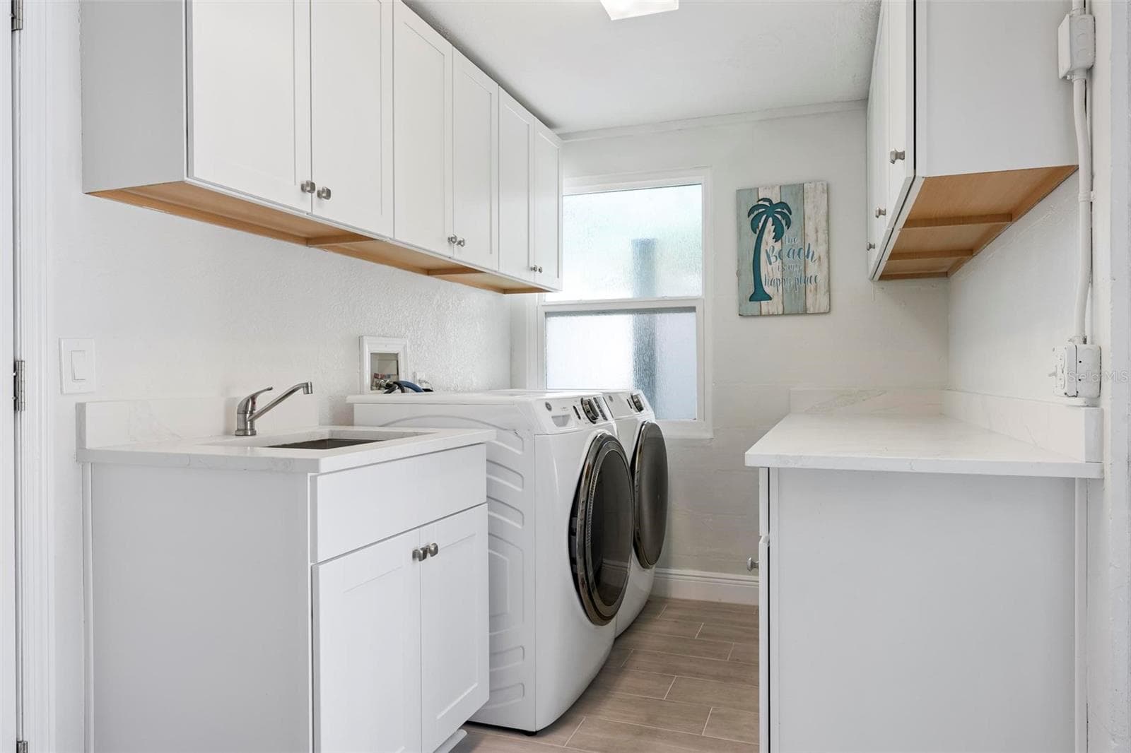 Indoor laundry room with utility sink and storage - 504 69TH ST, HOLMES BEACH