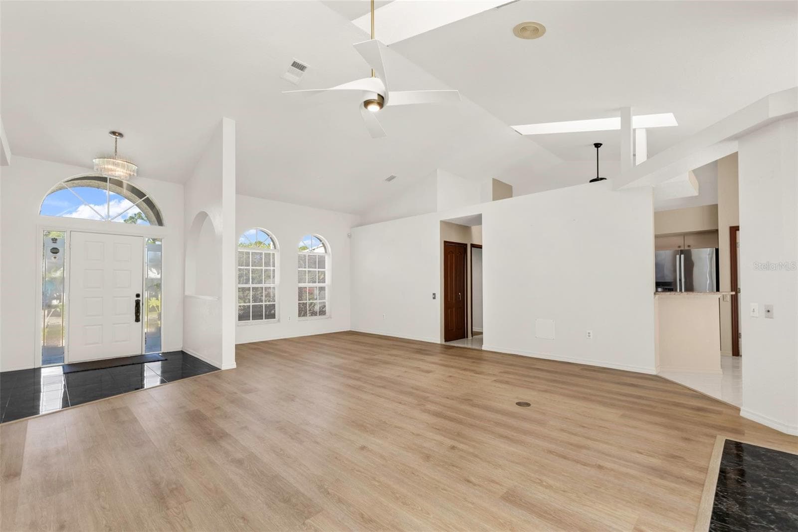 Living room looking at foyer and formal dinning or flex space - 5184 ELLSWORTH TER, PORT CHARLOTTE