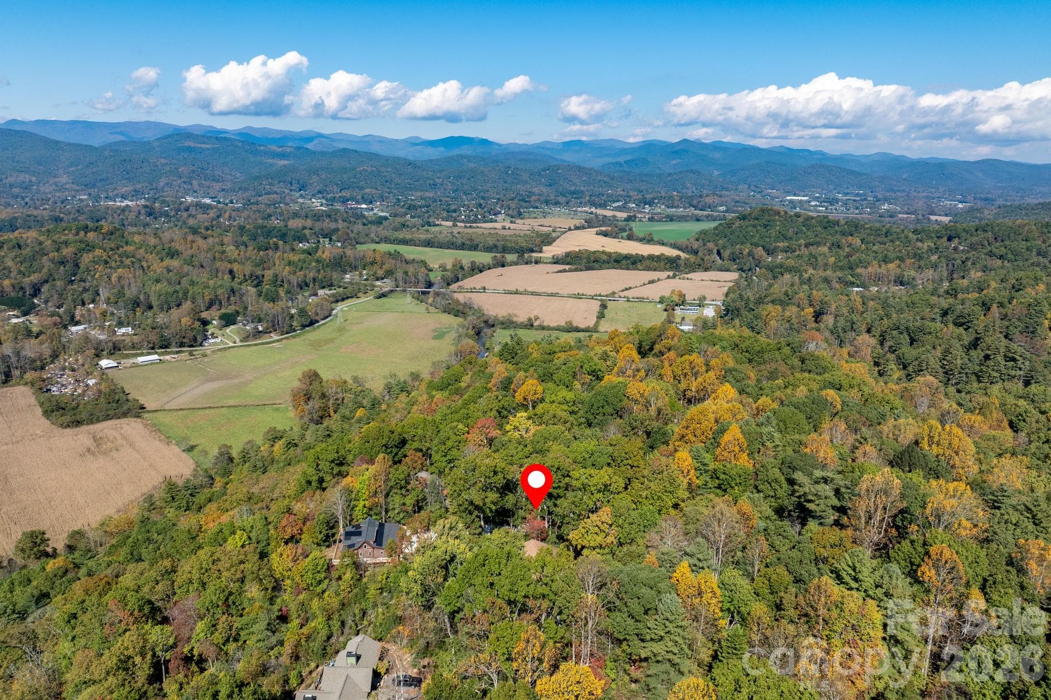 Breathtaking aerial panorama showcasing the surrounding mountain ranges, open farmland, and picturesque valleys. - 524 Three Mile Knob Road, Pisgah Forest