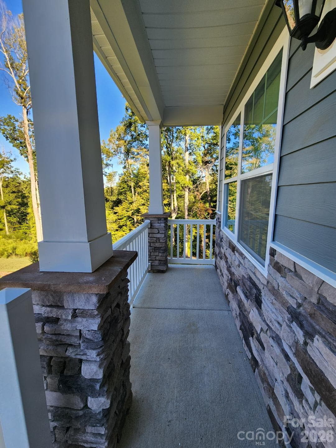 Front porch with vinyl handrails and spindles. - 3741 Stanley Creek Drive, Mount Holly