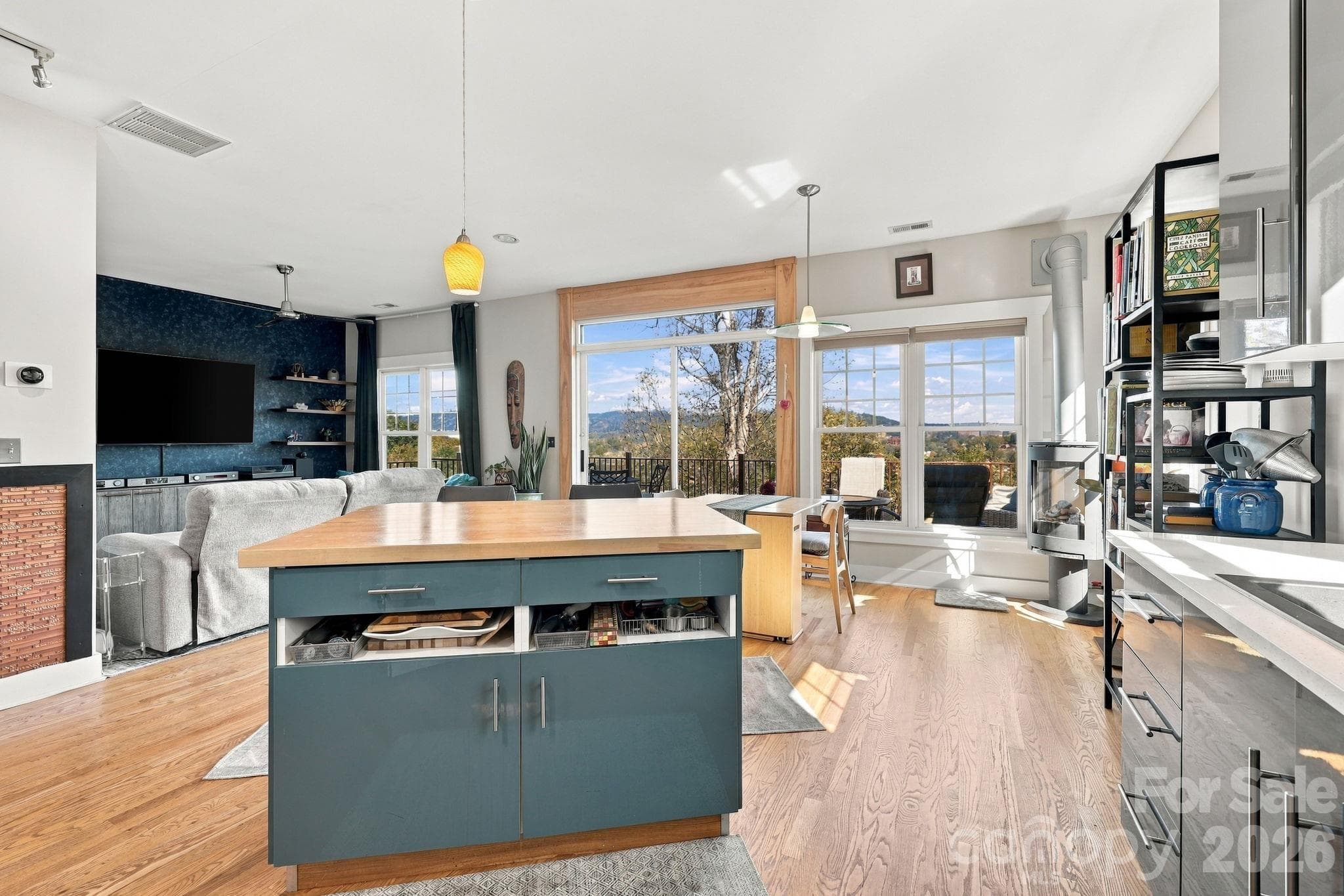 From the kitchen looking at the dining area and into the living room (views for days) - 272 Riverview Drive, Asheville
