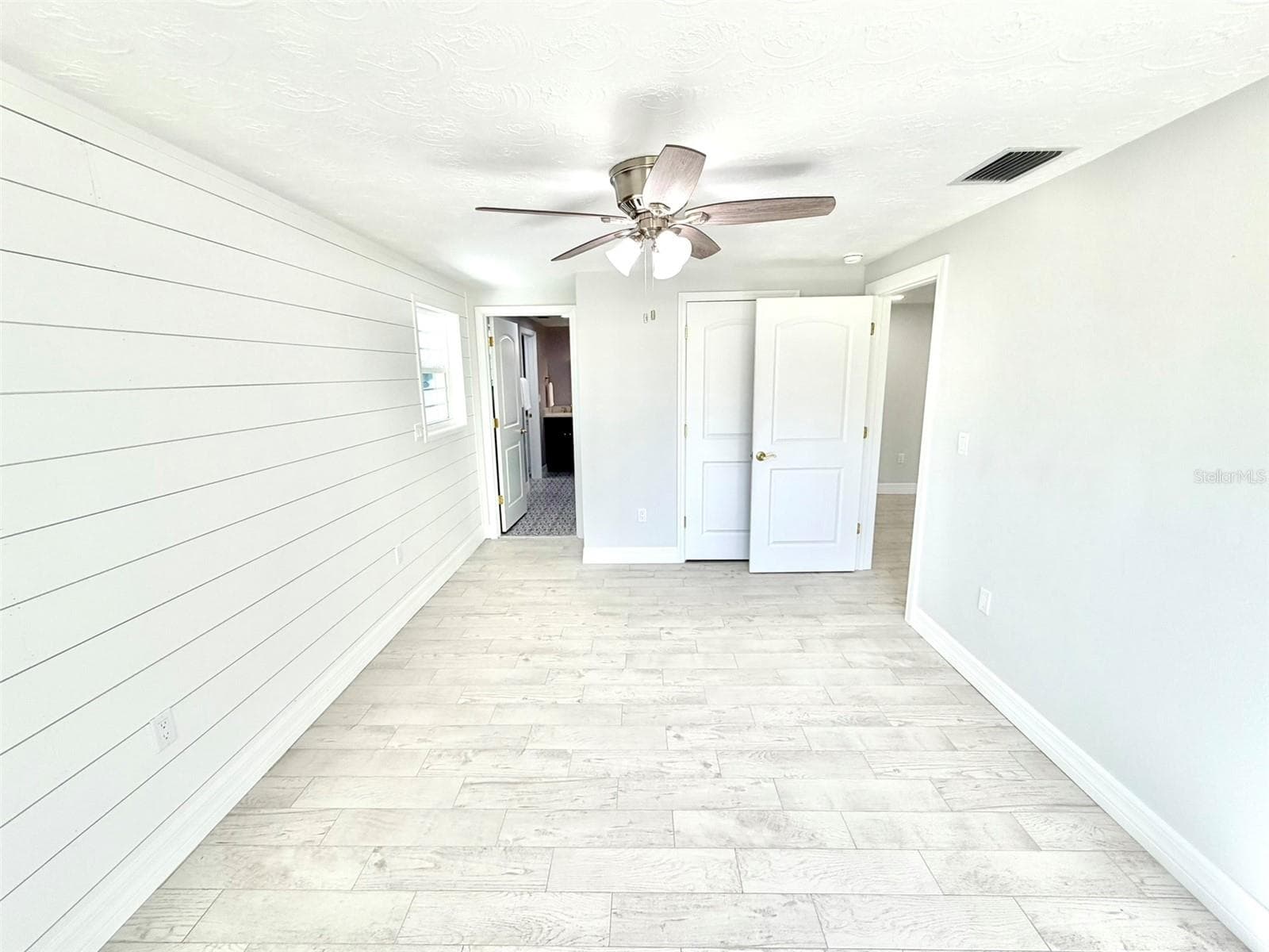 Primary Bedroom has a walk in closet and ensuite bath. - 336 SHADDOCK ST, TARPON SPRINGS
