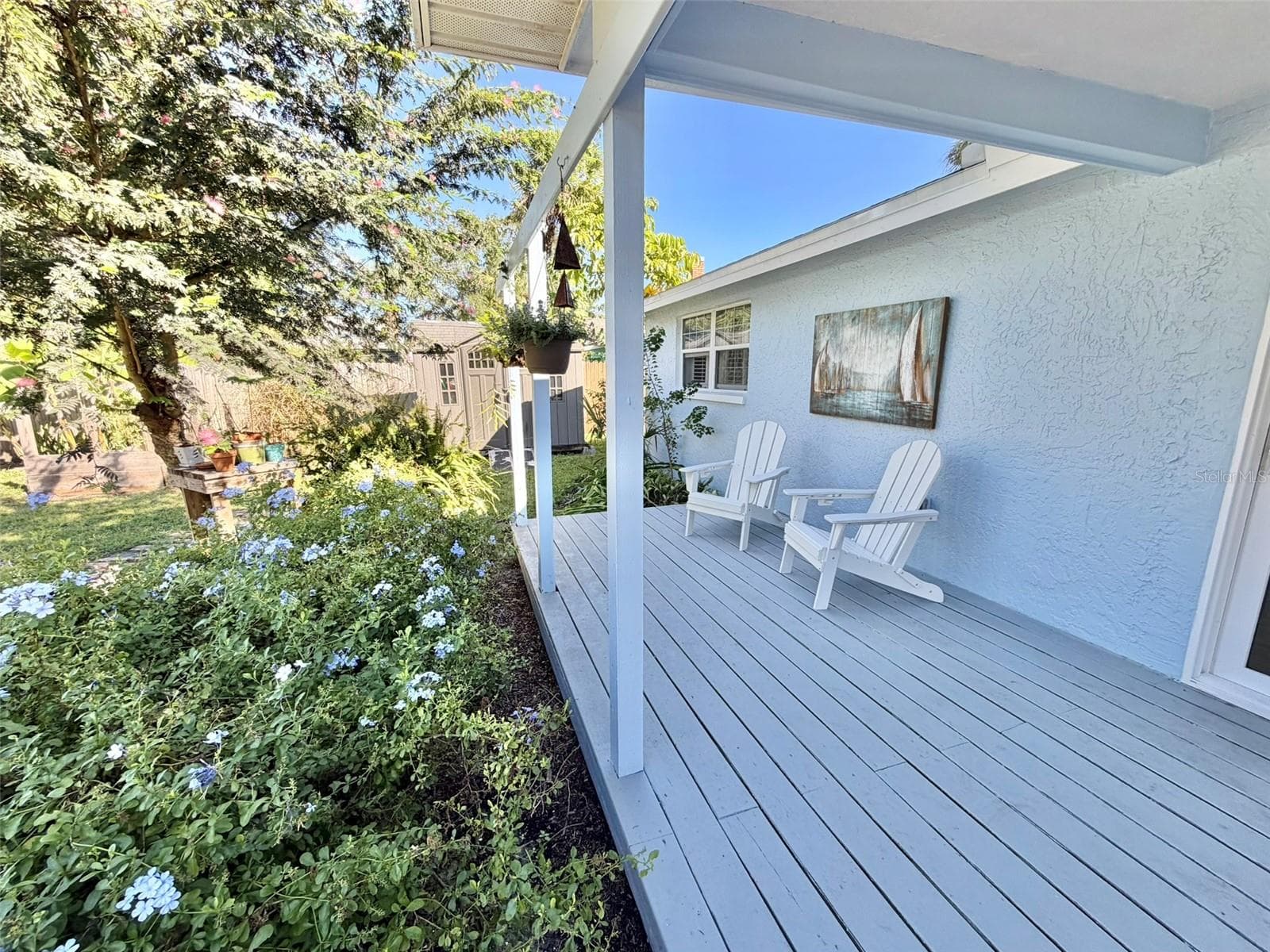A Large Deck in the back yard is partially covered for all weather enjoyment. - 336 SHADDOCK ST, TARPON SPRINGS