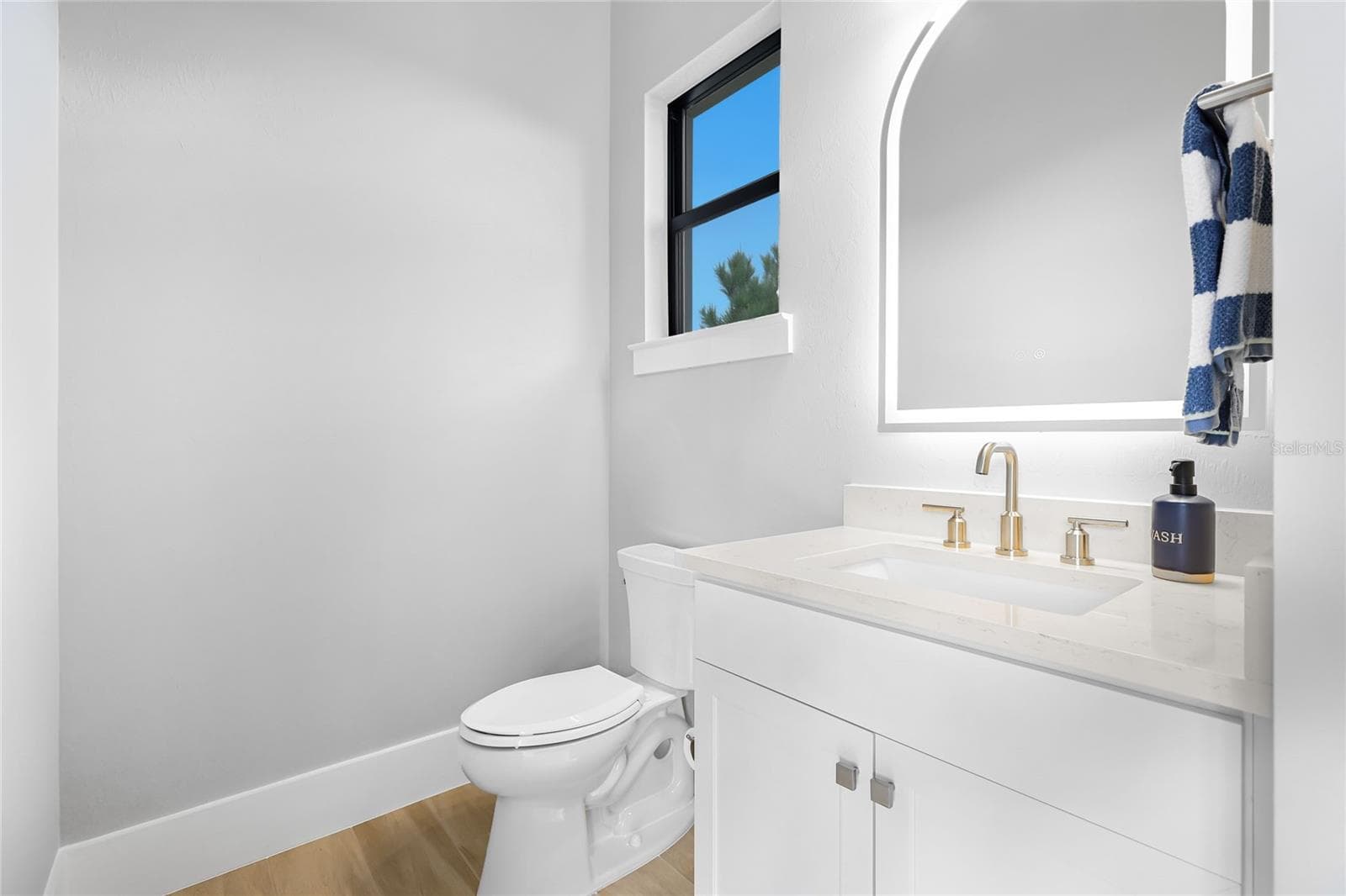 Pool Bath with under cabinetry lighting and illuminating mirror. - 14726 EAGLE BRANCH DR, NOKOMIS