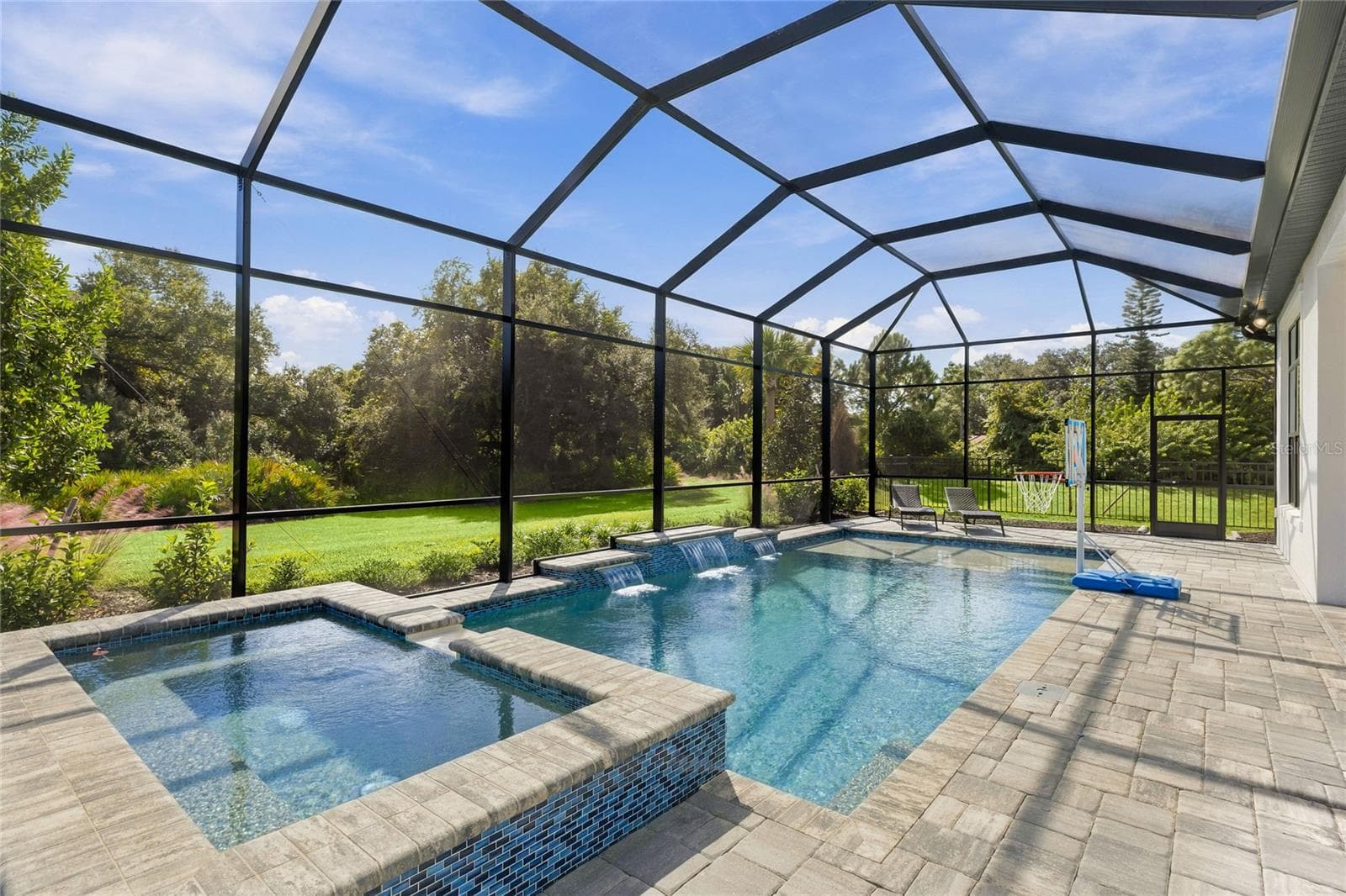 Custom Saltwater Pool with expansive spillover Spa, additional water features and Pool Shelf. - 14726 EAGLE BRANCH DR, NOKOMIS