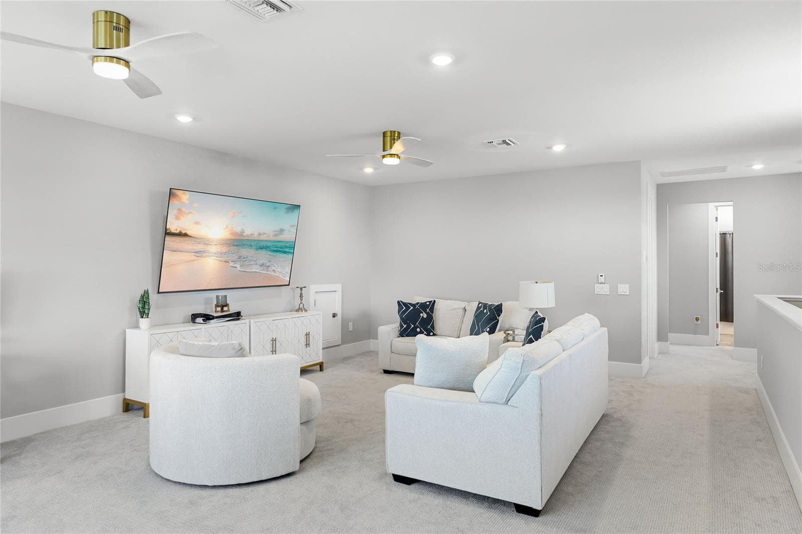 Light-filled bonus room featuring ample windows and transom windows, offering a versatile space ideal for a second TV room, home office, or additional gathering area—perfect for entertaining guests and enjoying quality time with family - 14726 EAGLE BRANCH DR, NOKOMIS