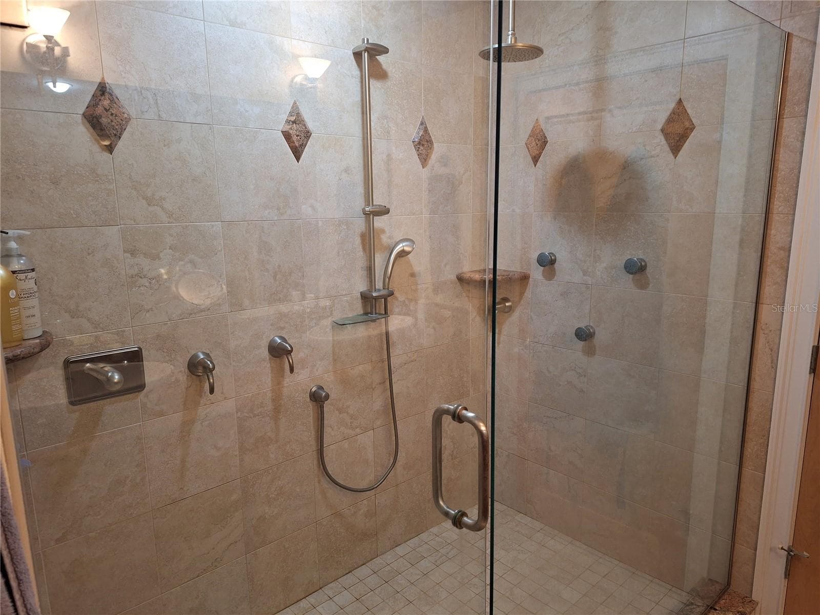 Primary Bedroom with huge walk-in shower with multiple shower heads. - 456 W 10TH AVE, MOUNT DORA