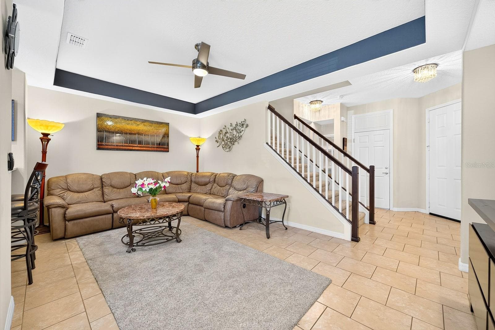 The Living Room features an ELEGANT TRAY CEILING and modern ceiling fan. - 2109 VICTORIA GLEN DR, SANFORD