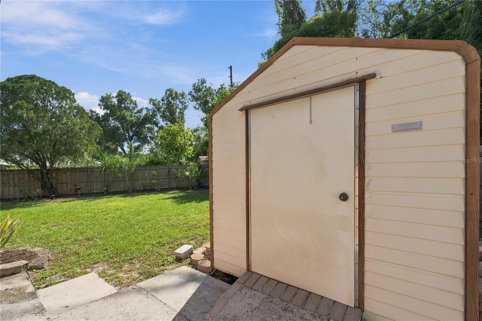 73. Elevated Metal Shed on Concrete Pad with Extended Slab for Ease of Use! - 112 PEACOCK CIR, SAFETY HARBOR