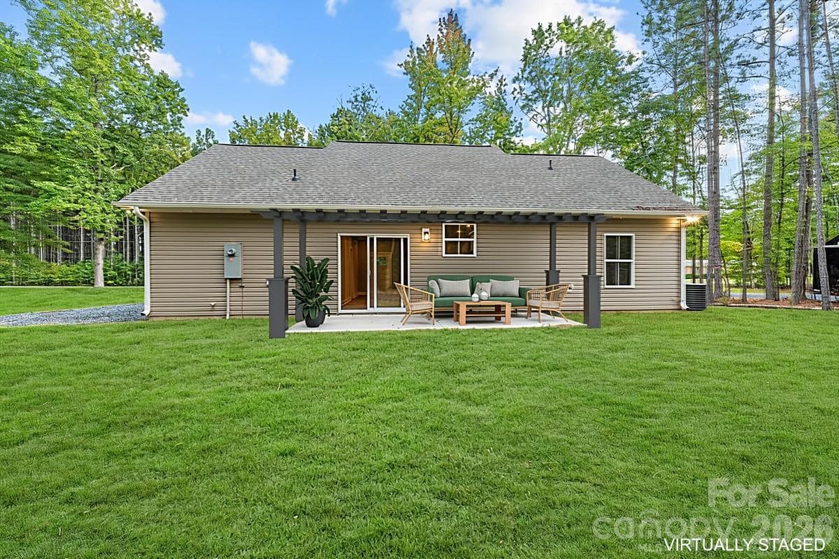 Virtually enhanced grass and virtually staged furniture/pergola. - 318 Stanback Street, Mount Gilead