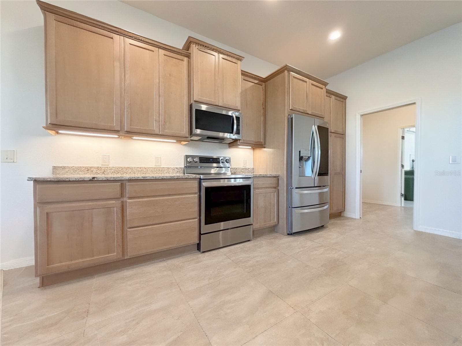 Kitchen with Granite Counter Top and Lighting Under Cabinets - 6240 PINEHURST LOOP, WINTER HAVEN