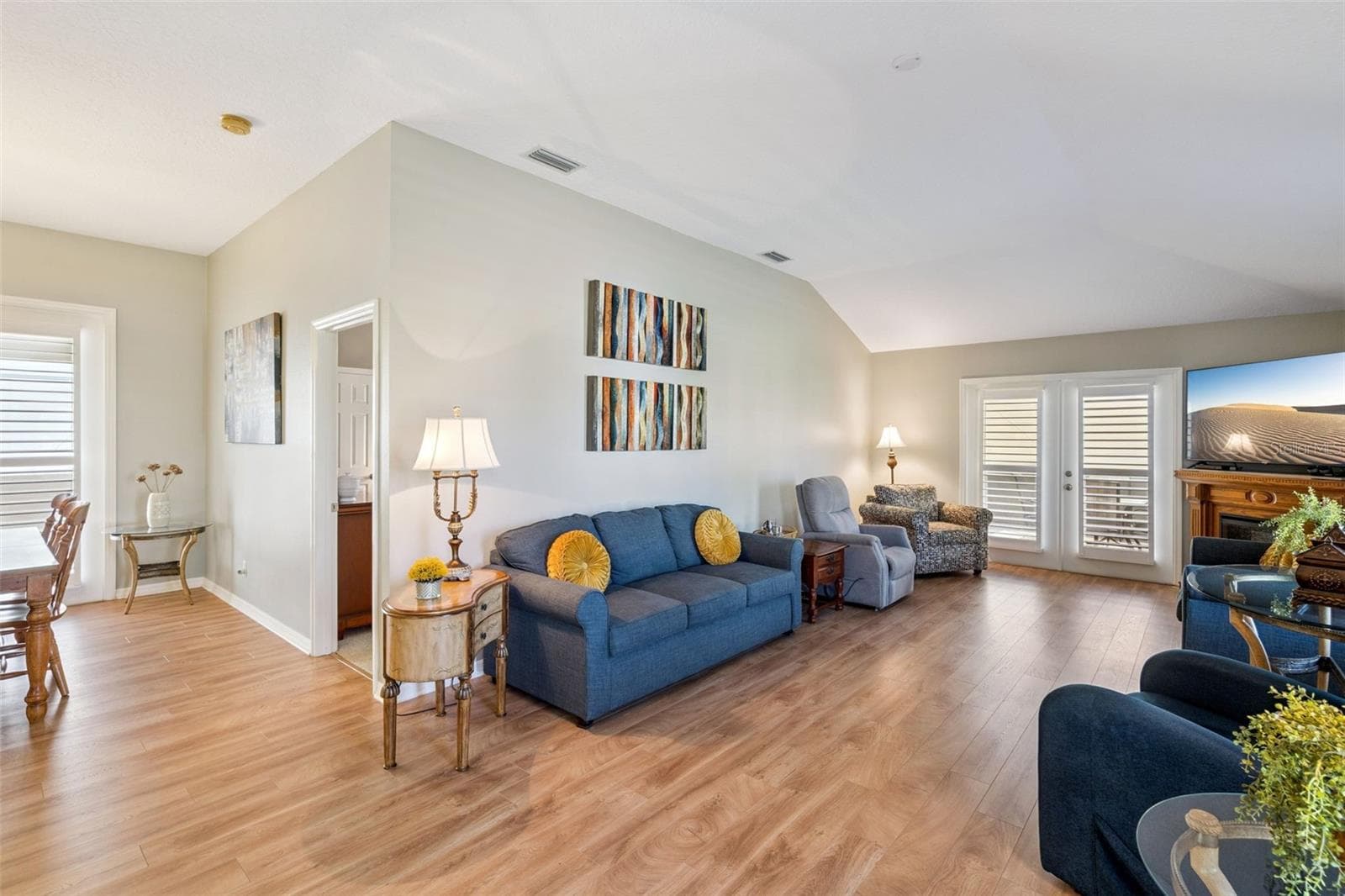 Vaulted Living Room with French doors to the larger screened lanai. - 4900 CANOE CT, TAVARES