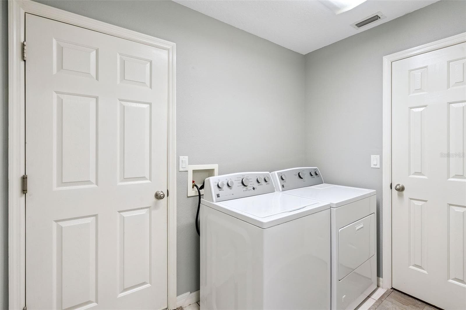 Inside laundry room has additional storage pantry. - 4900 CANOE CT, TAVARES