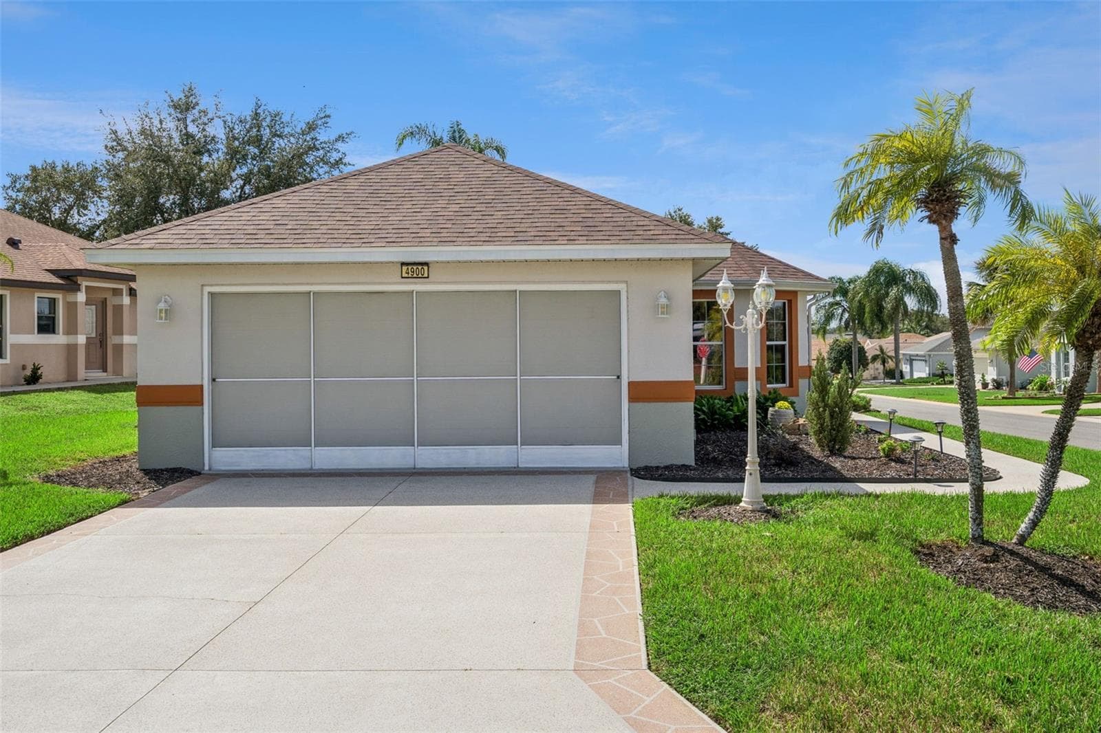 Coated driveway and screened door for garage. - 4900 CANOE CT, TAVARES