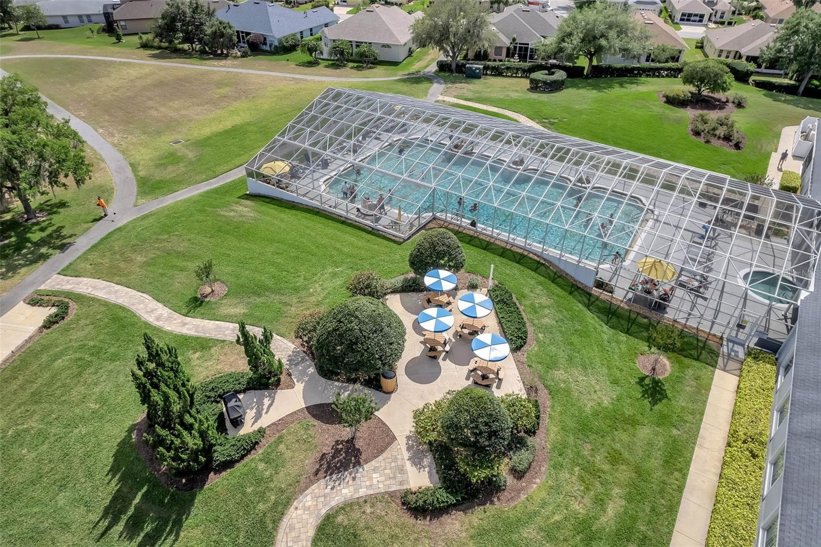 Pool with shaded picnic tables. - 4900 CANOE CT, TAVARES