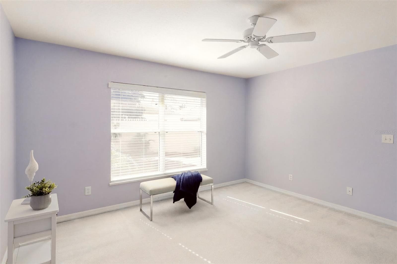 The primary bedroom suite offers serene backyard views - 3437 GRENVILLE DR, WINTER HAVEN