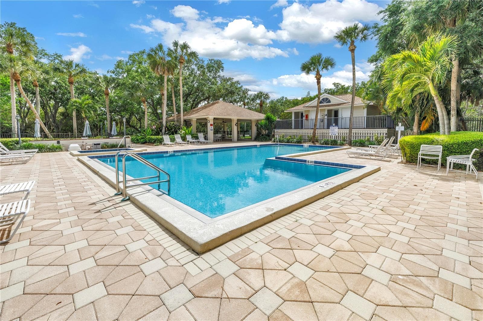 This image features well-appointed community swimming pool changing rooms and bathroom facilities. - 1186 GASPARILLA DR NE, ST PETERSBURG