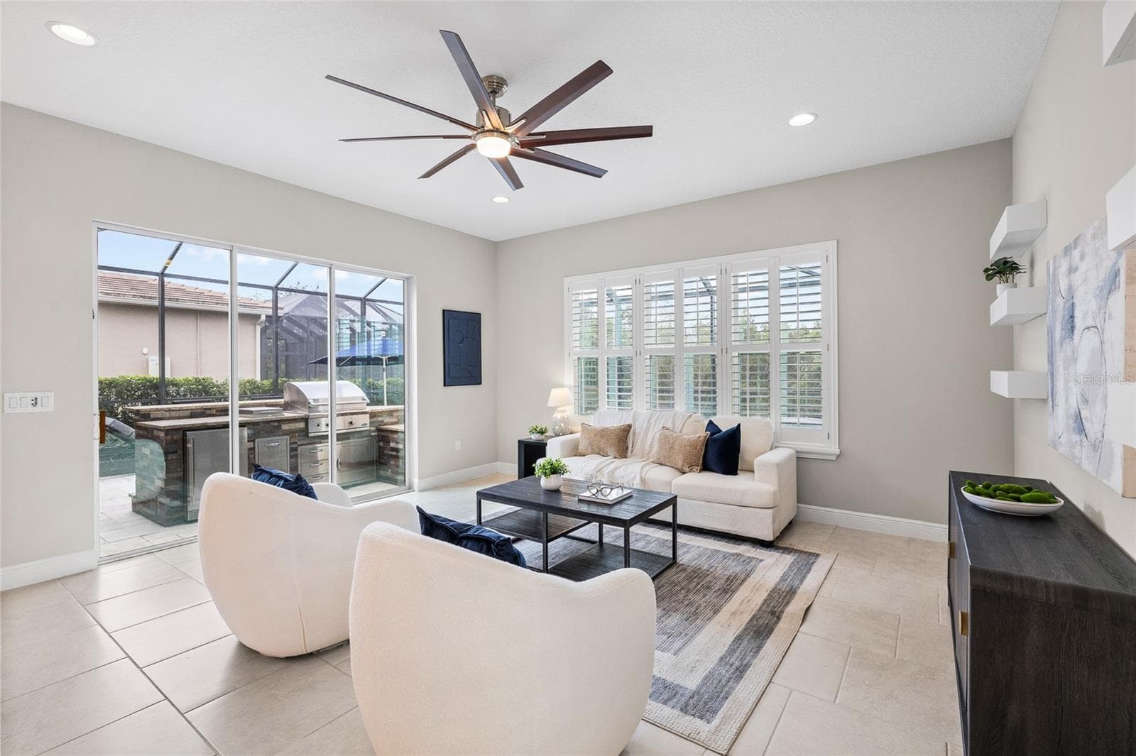 Living room with sliders to outdoor kitchen and pool area - 30351 TRISTANIA CT, WESLEY CHAPEL