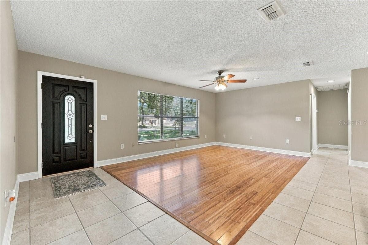 Living area open to dining and kitchen. - 5244 QUIET CREEK LN, LAKELAND
