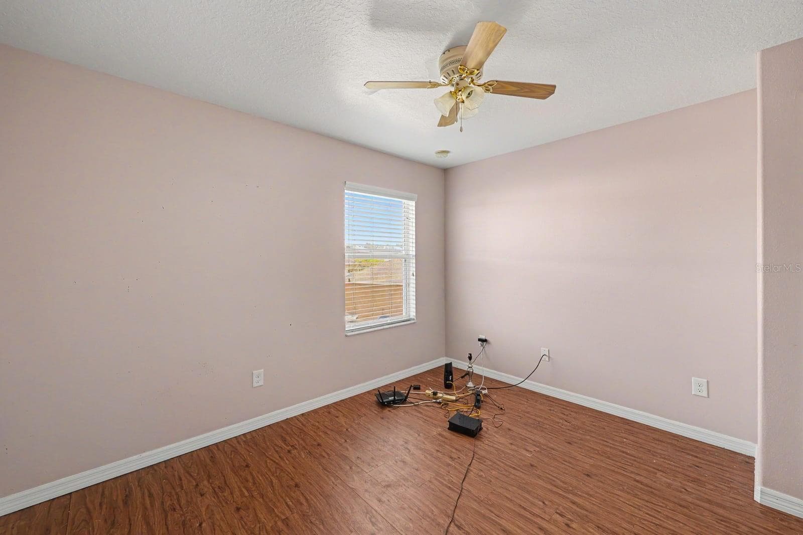 Spacious Bedroom with Wood Flooring, Large Window & Ceiling Fan - 5705 NEW INDEPENDENCE PKWY, WINTER GARDEN