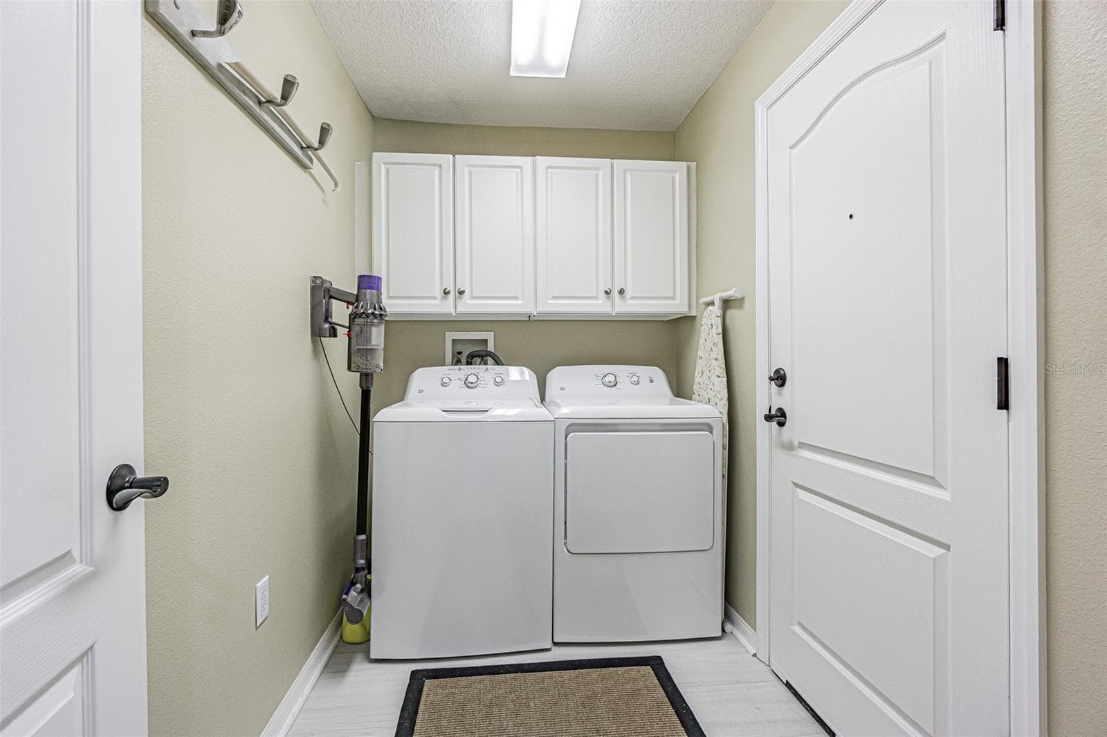 Interior laundry room with storage cabinets above - 11020 JENKINS CT, SAN ANTONIO