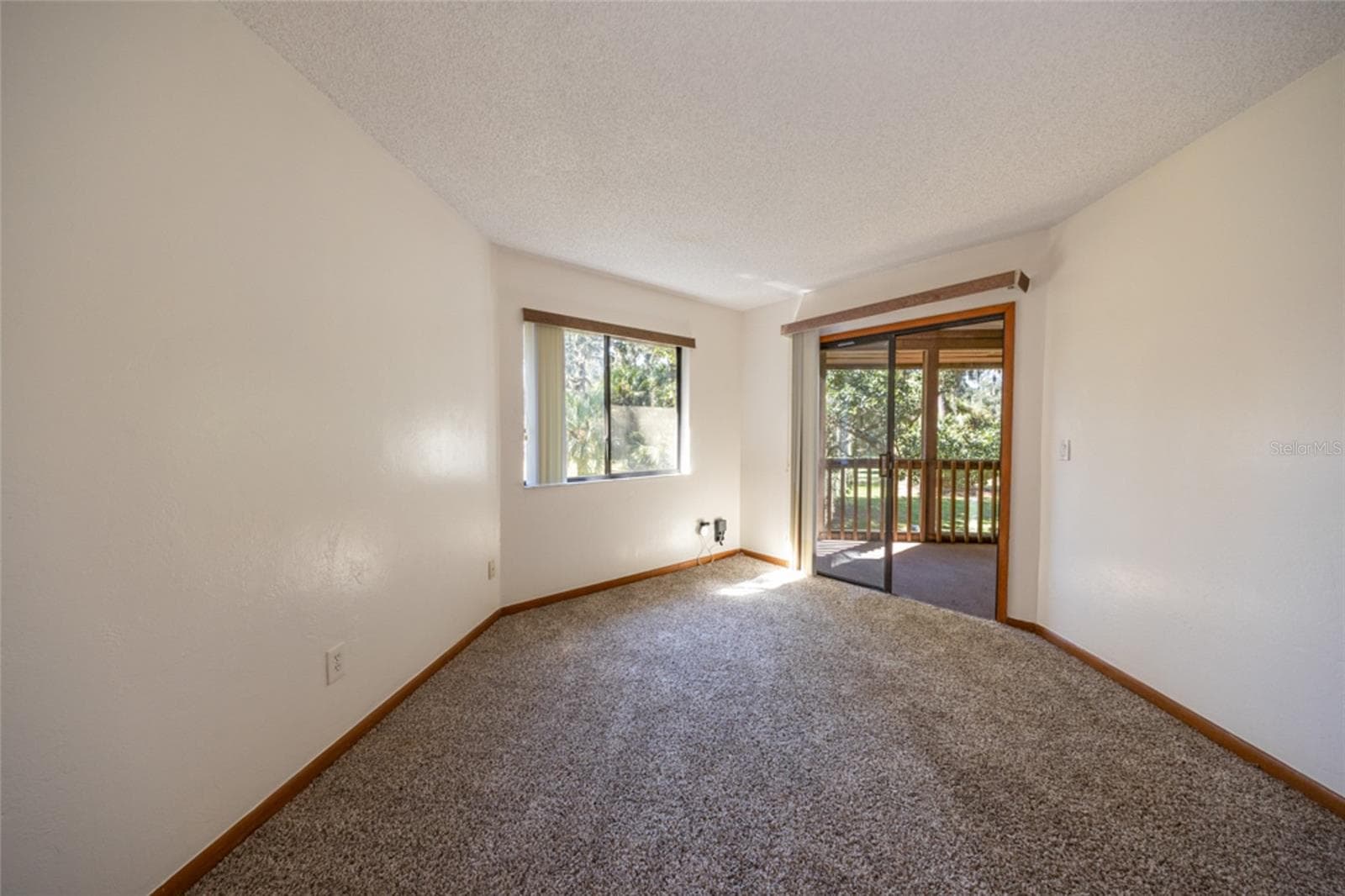 Primary Suite With Sliders That Open To the Screened Patio - 12 FAIRWAYS CIR #12, PALM COAST