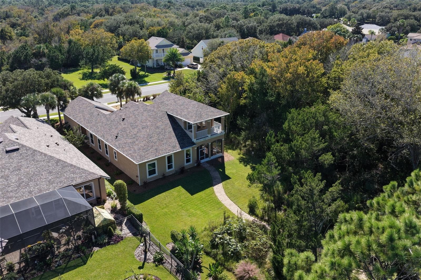 A spacious backyard surrounded by natural greenery, offering privacy and a peaceful setting to enjoy the outdoors. - 25 EMERALD LAKE CT, PALM COAST