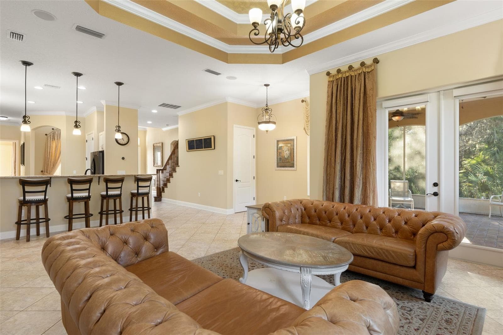 French doors open to the screened lanai, while the adjoining kitchen and breakfast bar create a natural flow for everyday living and entertaining. - 25 EMERALD LAKE CT, PALM COAST