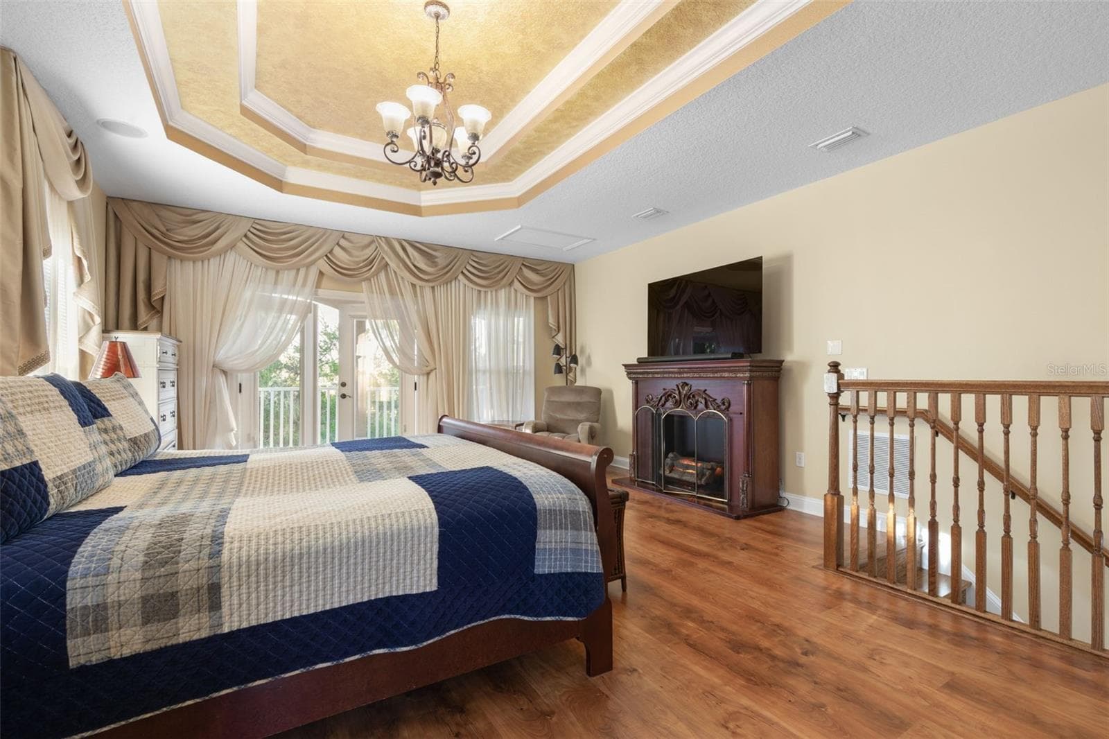French doors open to a private balcony overlooking the wooded surroundings, offering a peaceful escape just steps from the bedroom. - 25 EMERALD LAKE CT, PALM COAST