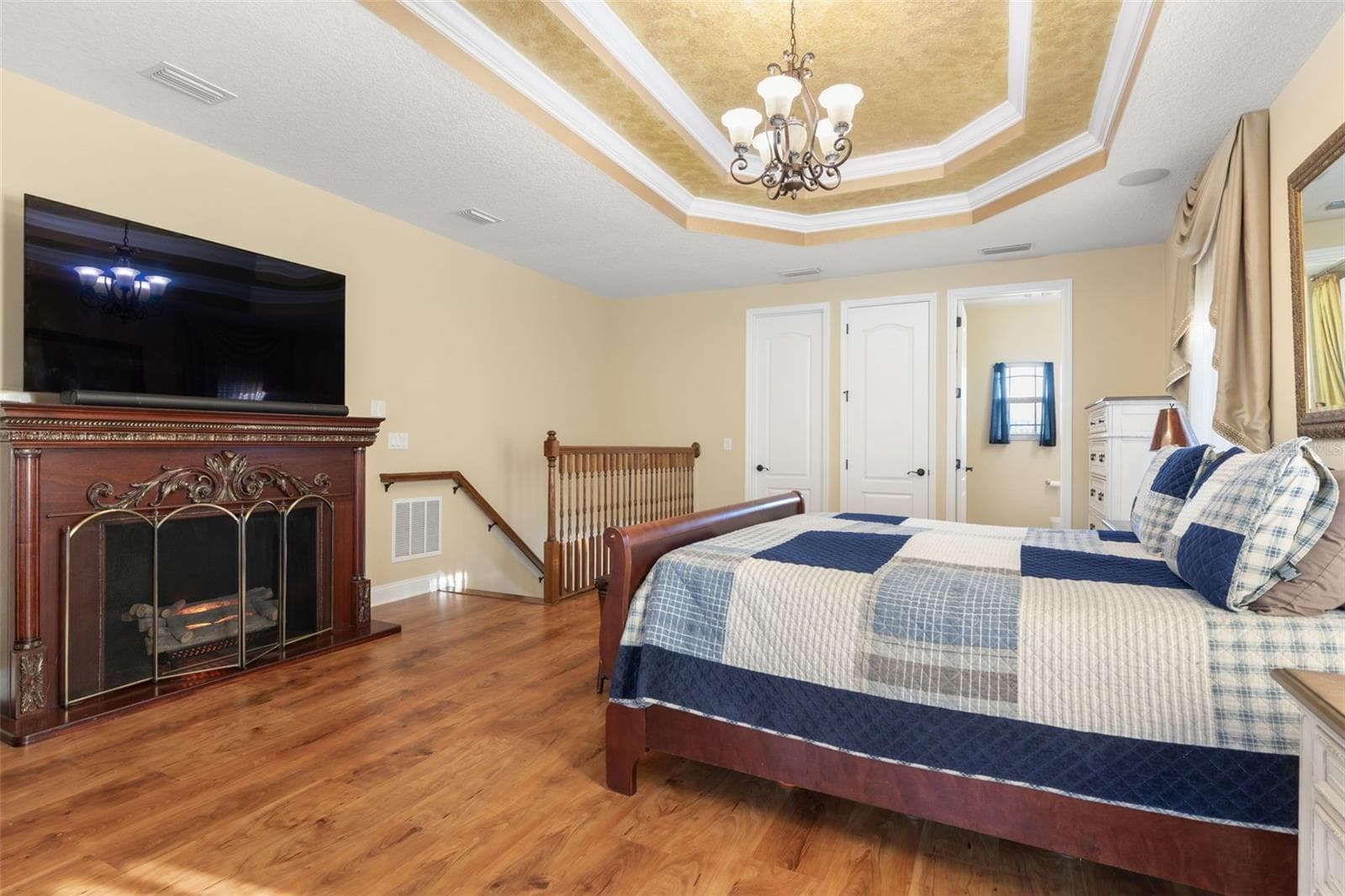 Warm wood-look flooring, an elegant tray ceiling and generous living space create a comfortable setting for a private upstairs retreat. - 25 EMERALD LAKE CT, PALM COAST