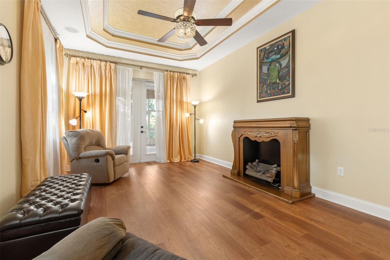 A peaceful space to relax and unwind, with warm wood-look flooring and a comfortable sitting area overlooking the natural surroundings. - 25 EMERALD LAKE CT, PALM COAST