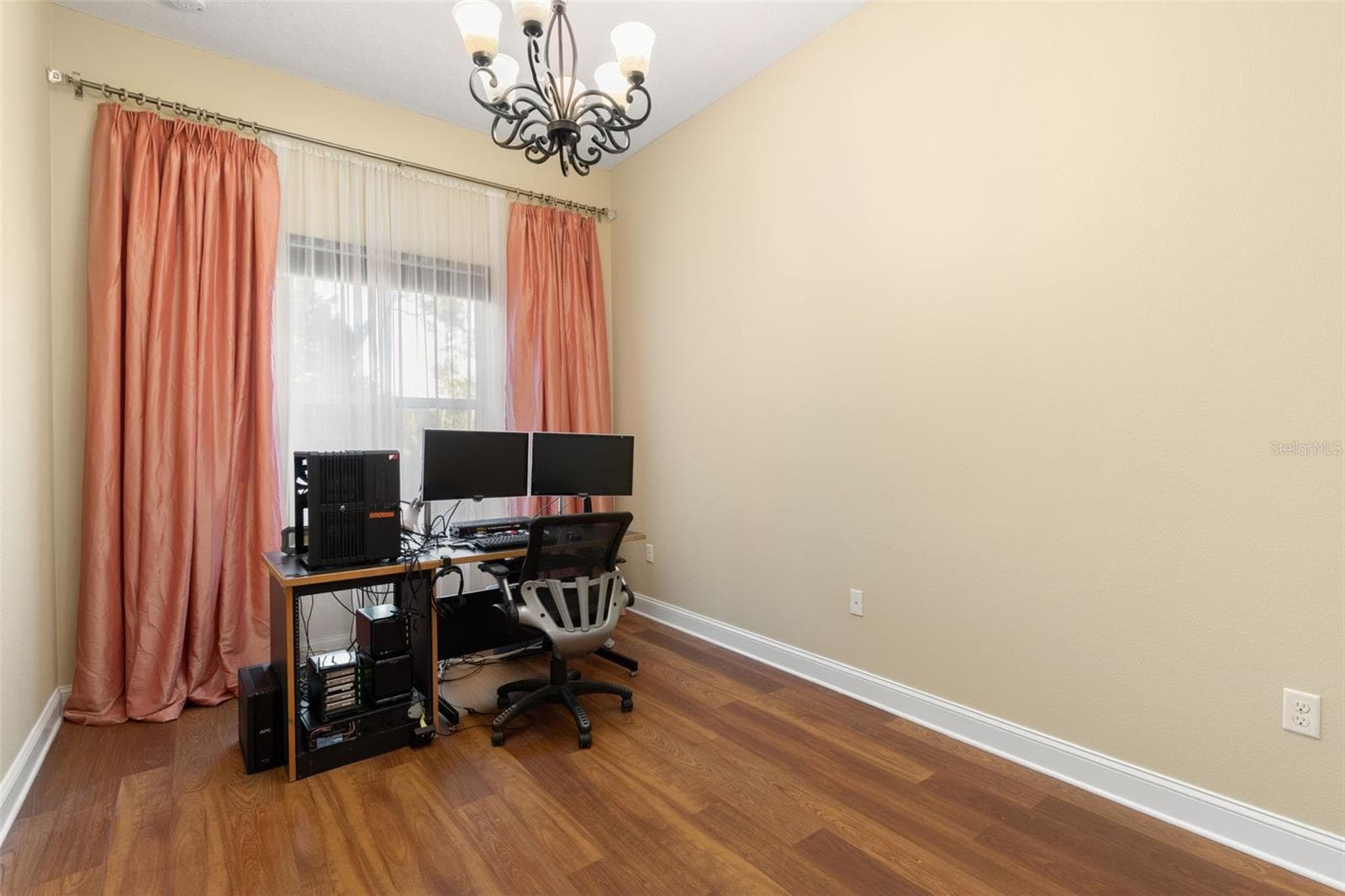 First-Floor Bedroom #3 is currently used as a home office, offering a versatile space that can easily accommodate a variety of needs. - 25 EMERALD LAKE CT, PALM COAST