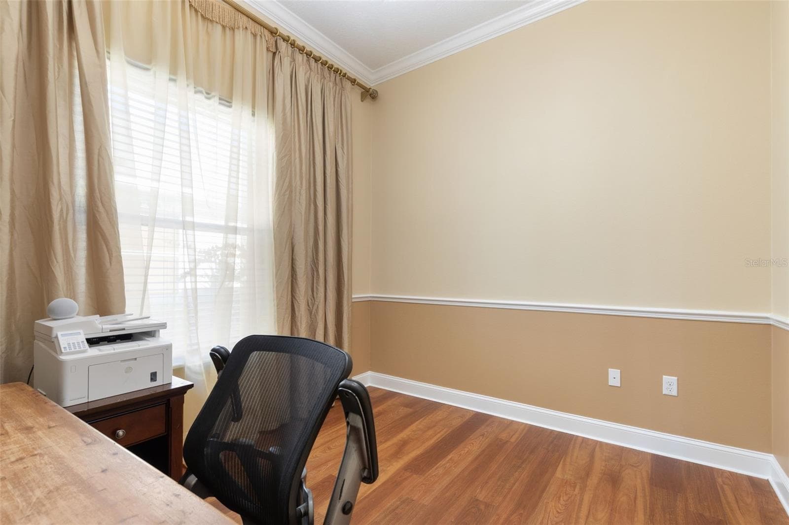 Another view of First-Floor Bedroom #3 highlights the closet space, warm wood-look flooring, and flexibility to personalize the room. - 25 EMERALD LAKE CT, PALM COAST