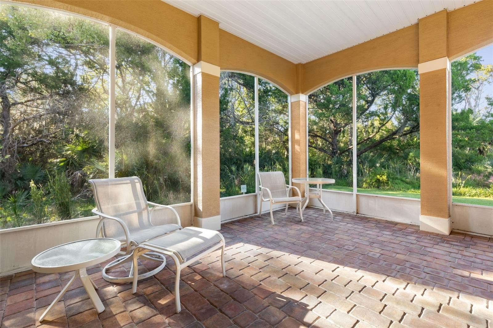 Relaxed indoor–outdoor living on the spacious screened lanai with peaceful conservation views. - 25 EMERALD LAKE CT, PALM COAST